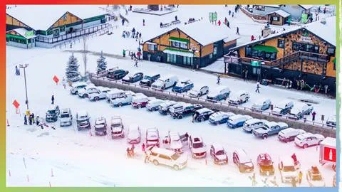 Drone shot of Snow Summit's parking lot with new snowfall